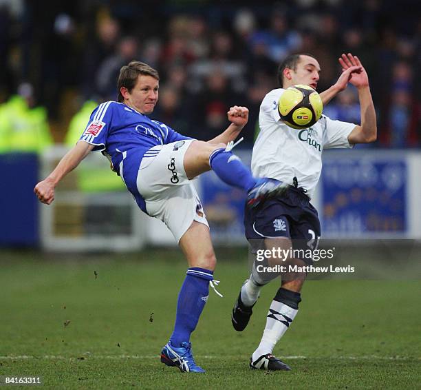 Terry Dunfield of Macclesfield Town clears under pressure from Leon Osman of Everton during the FA Cup sponsored by E.on 3rd Round match between...