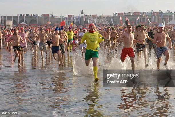 Belgians take to the water during a traditional new year's dive into the north sea, at 'Drie Gapers' beach, in Oostende on January 3, 2009. The water...