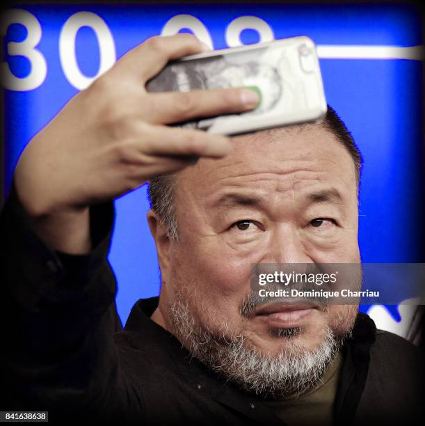 Ai Weiwei takes selfie as he attends the 'Human Flow' photocall during the 74th Venice Film Festival on September 1, 2017 in Venice, Italy.