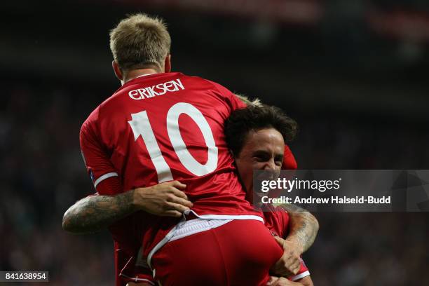 Christian Eriksen celebrates with Thomas delaney after Delaney scored the first goal for Denmark during the FIFA 2018 World Cup Qualifier between...