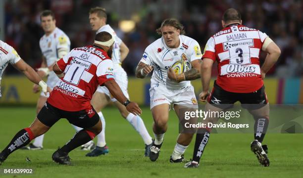 Harry Williams of Exeter takes on John Afoa and Fraser Balmain during the Aviva Premiership match between Gloucester Rugby and Exeter Chiefs at...