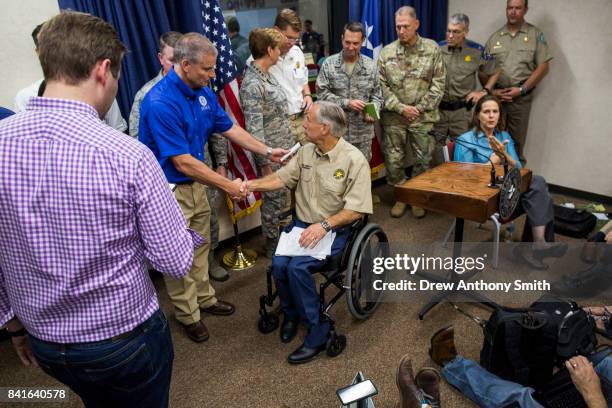 Texas Governor Greg Abbott departs a briefing to the public on Hurricane Harvey at the Texas Department of Public Safety building on September 1,...