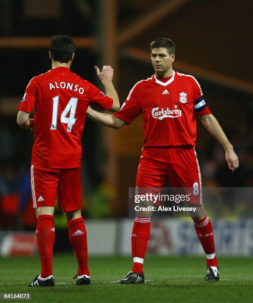 Steven Gerrard of Liverpool shakes hands with team mate Xabi Alonso prior to the FA Cup sponsored by E.ON Third Round match between Preston North End...