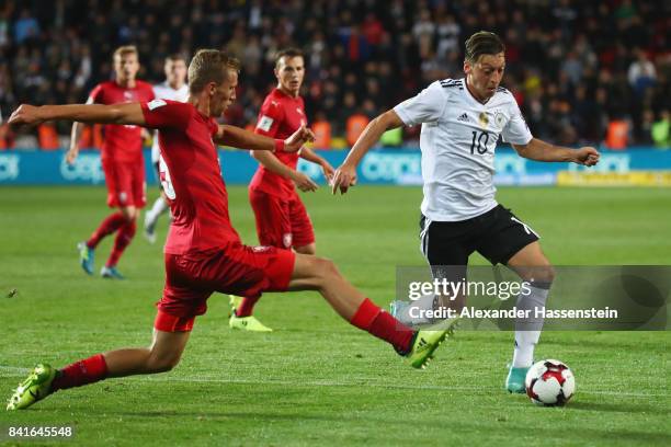 Mesut Oezil of Germany is challenged by Tomas Soucek of Czech Republik during the FIFA World Cup Russia 2018 Group C Qualifier between Czech Republic...