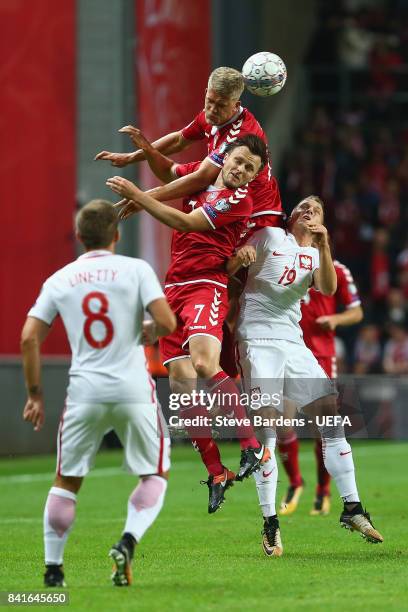 Andreas Cornelius of Denmark wins a header from Piotr ZieliÅsk of Poland and William Kvist of Denmark during the FIFA 2018 World Cup Qualifier...