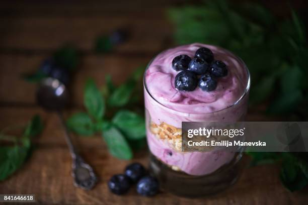 yogurt with blueberries on wooden background - buttermilk biscuit stock-fotos und bilder