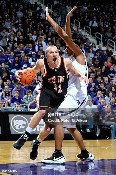 Forward Felix Caspari of the Idaho State Bengals drives the baseline around pressure from forward Ron Anderson of the Kansas State Wildcats during...