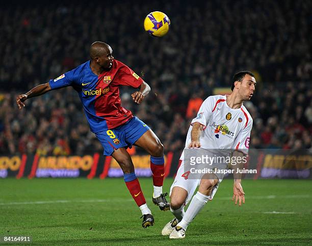 Samuel Eto'o of Barcelona duels for the ball with Ivan Ramis of Mallorca during the La Liga match between Barcelona and Mallorca at the Camp Nou...