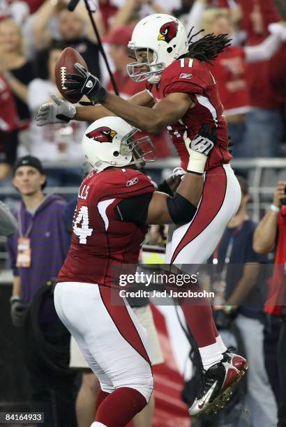 Wide receiver Larry Fitzgerald of the Arizona Cardinals celebrates with Reggie Wells after scoring on a 42 yard touchdown reception against the...