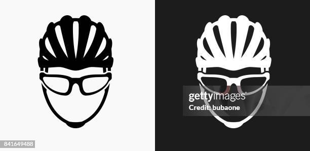 bike helmet icon on black and white vector backgrounds - cycling helmet stock illustrations