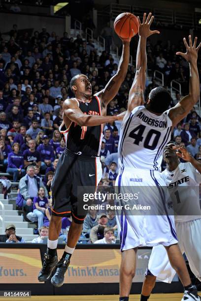 Guard Amorrow Morgan of the Idaho State Bengals puts up a shot over forward Ron Anderson the Kansas State Wildcats during the first half on January...