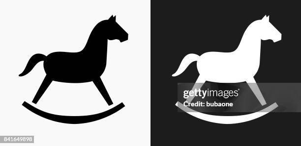 rocking horse toy icon on black and white vector backgrounds - white horse on black background stock illustrations