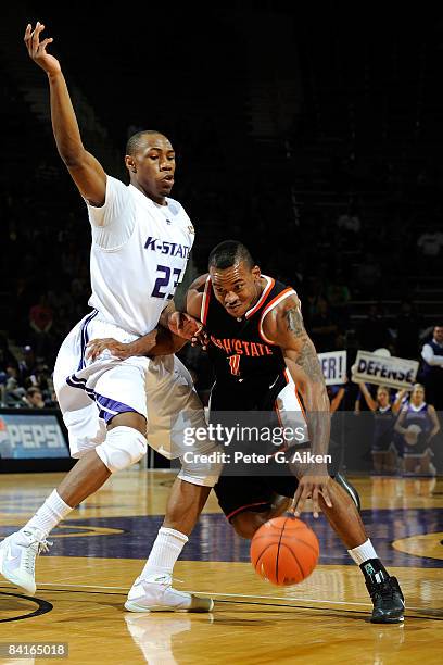 Guard Amorrow Morgan of the Idaho State Bengals drives around pressure during he first half against forward Dominique Sutton of the Kansas State...