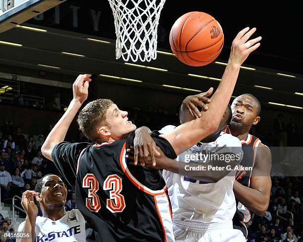 Forward Jamar Samuels of the Kansas State Wildcats battles for the ball against defenders Deividas Busma and Chron Tatum of the Idaho State Bengals...