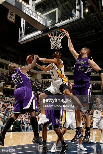 Stephen Graham of the Indiana Pacers battles for the ball with Bobby Jackson and Brad Miller of the Sacramento Kings at Conseco Fieldhouse on January...