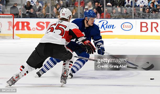 Alexei Ponikarovsky of the Toronto Maple Leafs carries the puck up ice as Brian Lee of the Ottawa Senators defends during game action January 3, 2009...