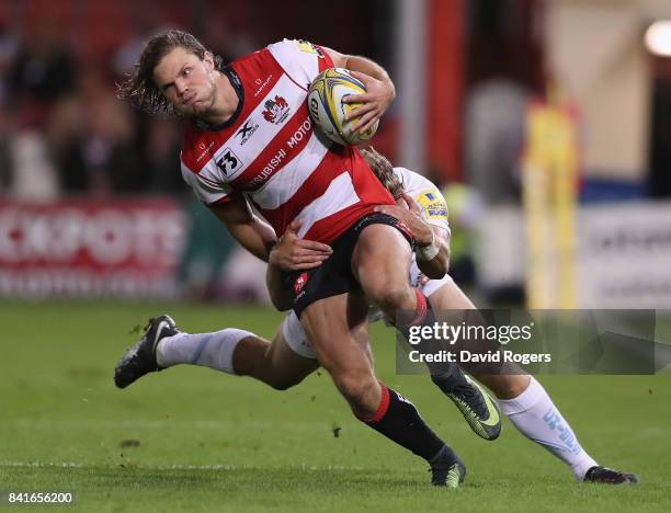 Henry Purdy of Gloucester is tackled during the Aviva Premiership match between Gloucester Rugby and Exeter Chiefs at Kingsholm Stadium on September...