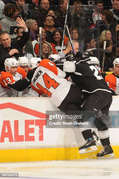 Kimmo Timonen of the Philadelphia Flyers is checked over the boards by Dustin Brown of the Los Angeles Kings during the game on January 3, 2009 at...