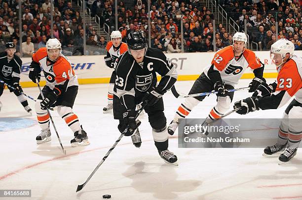 Kimmo Timonen, Mike Knuble and Ossi Vaananen of the Philadelphia Flyers defend as Dustin Brown of the Los Angeles Kings handles the puck during the...