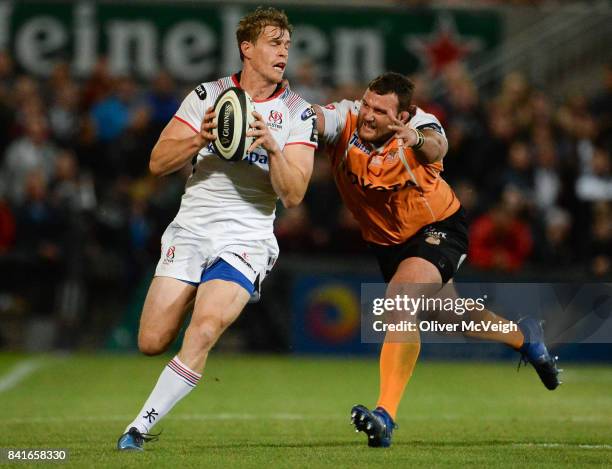 Belfast , United Kingdom - 1 September 2017; Andrew Trimble of Ulster is tackled by Johan Coetzee of Cheetahs during the Guinness PRO14 Round 1 match...
