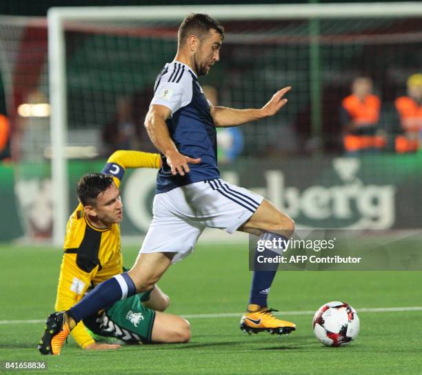 Scotland's James McArthur vies with Lithuania's Mantas Kuklys during the FIFA World Cup 2018 qualification football match between Lithuania and...