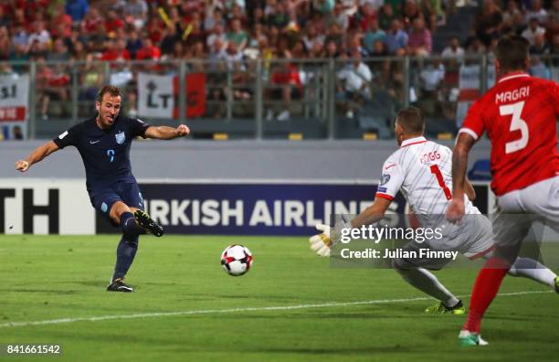 Harry Kane of England scores their first goal past Andrew Hogg of Malta during the FIFA 2018 World Cup Qualifier between Malta and England at Ta'Qali...