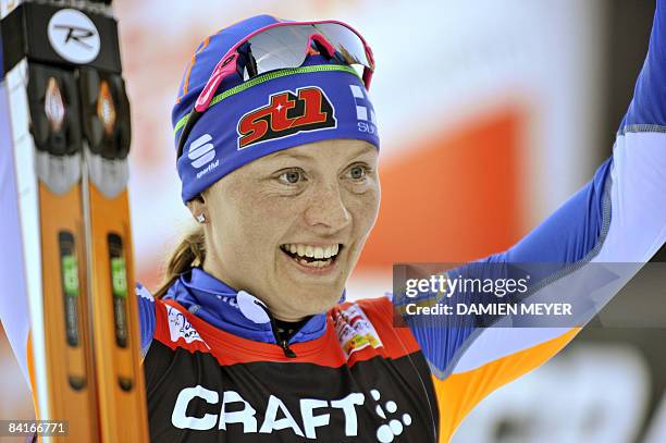 Finland's Virpi Kuitunen celebrates after winning the 9km free final climb pursuit of the FIS Ski Tour in Val di Fiemme, on January 4, 2009. AFP...