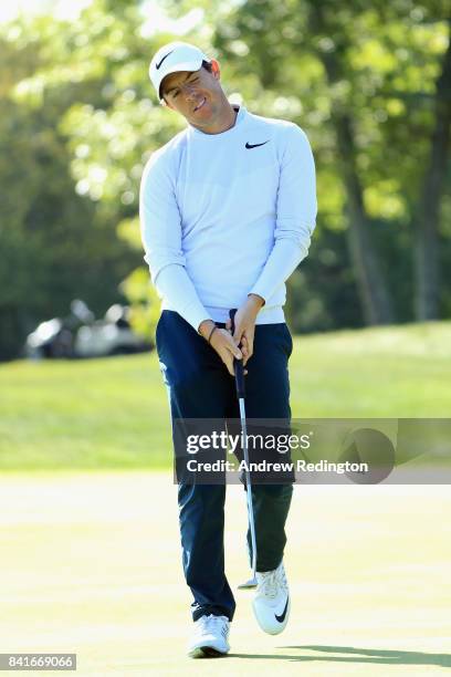 Rory McIlroy of Northern Ireland reacts after missing a putt on the 13th green during round one of the Dell Technologies Championship at TPC Boston...