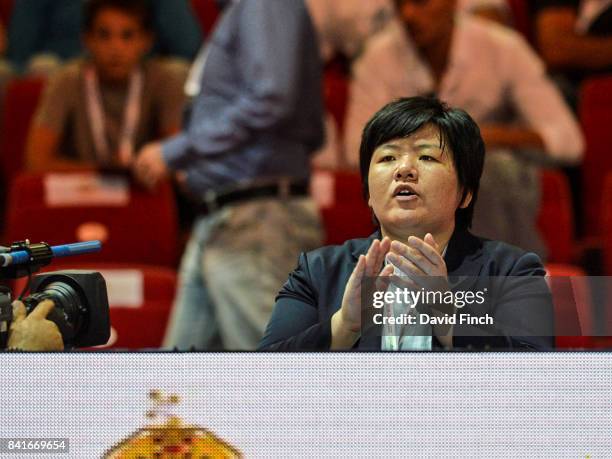 Filmed by the camera, former Olympic and World champion, Maki Tsukada of Japan coaches the Japanese women's team from the side of the mat during the...