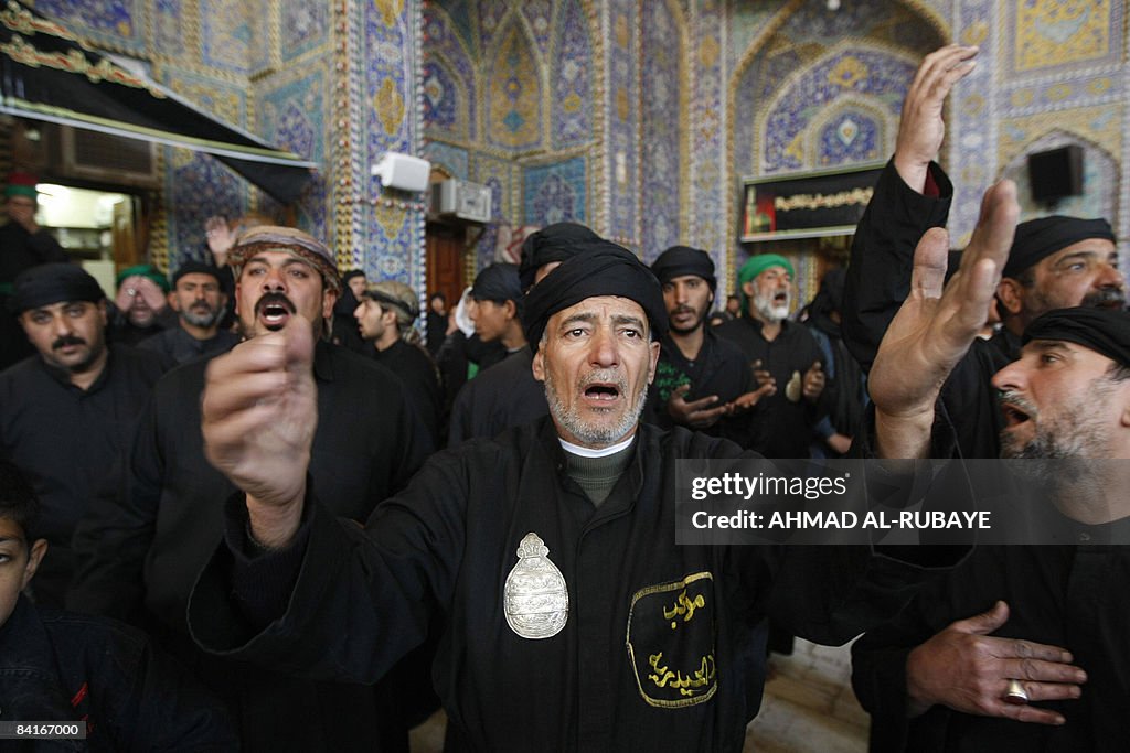 Iraqi Shiite Muslims beat their chests d