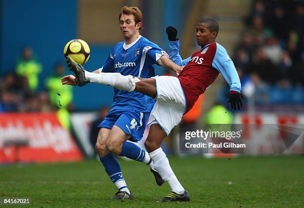 Stuart Lewis of Gillingham is tackled by Ashley Young of Aston Villa during the FA Cup sponsored by E.on third round match between Gillingham and...