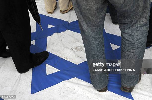 Moroccans walk on an Israeli flag as demonstrators rally at a protest against the Israeli invasion of Gaza, on January 4, 2009 in Rabat. Thousands of...