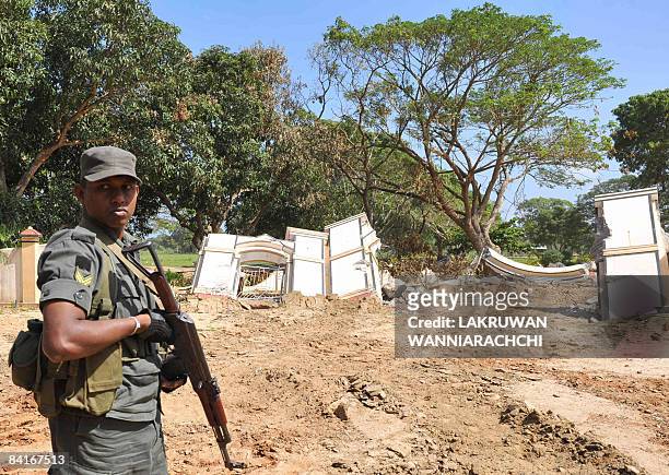 Sri Lanka's troops stand guard outside the war cemetery at the Tamil Tiger political capital town of Kilinochchi, some 330 kilometers north of...