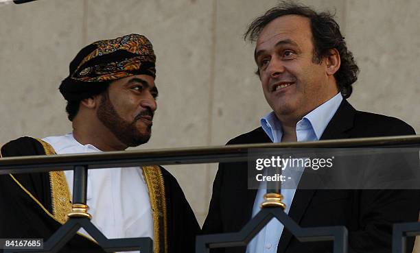 President Michel Platini shares a light moment with the head of Oman's Al-Suweiq club, Fatik bin Fahar al-Said , as they attend the first match of...