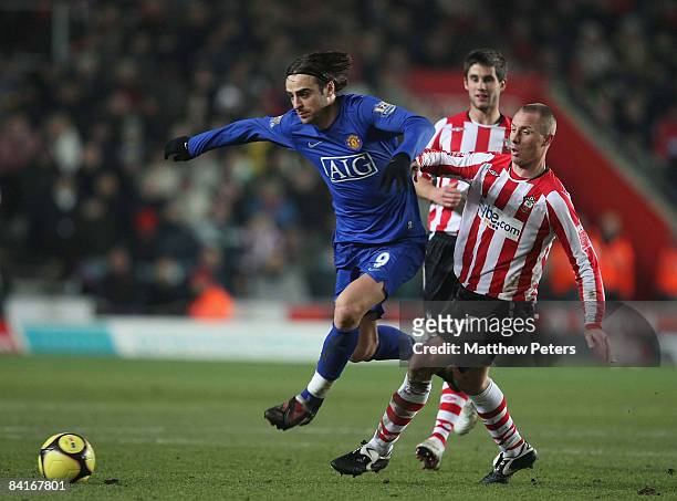 Dimitar Berbatov of Manchester United clashes with Chris Perry of Southampton during the FA Cup sponsored by e.on Third Round match between...