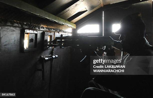 Sri Lankan Army soldier rides inside an armoured personnel carrier in the Tamil Tiger political capital town of Kilinochchi, some 330 kilometers...