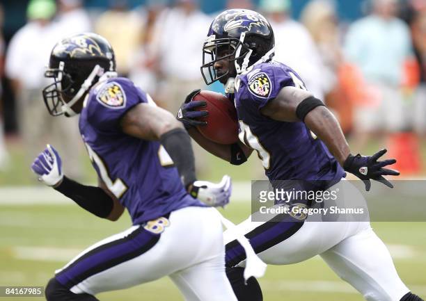 Ed Reed of the Baltimore Ravens looks for a block by Samari Rolle on his way to a touchdown after a second quarter interception against the Miami...