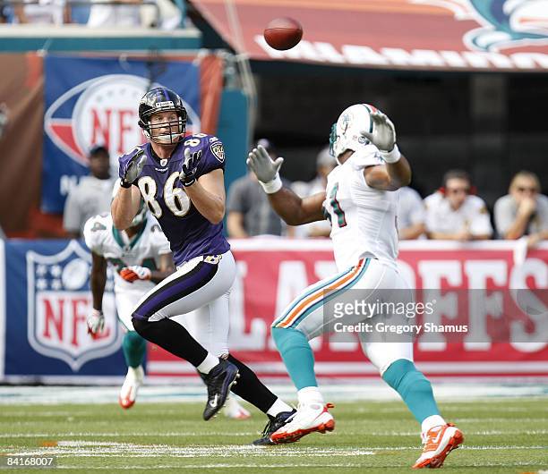 Todd Heap of the Baltimore Ravens catches a first quarter pass in front of Akin Ayodele of the Miami Dolphins during the AFC Wild Card playoff game...