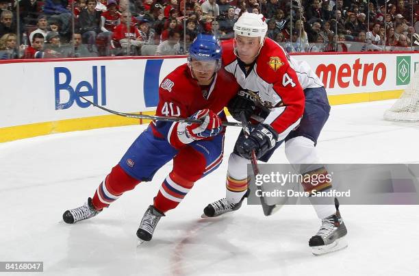 Jay Bouwmeester of the Florida Panthers battles for position with Maxim Lapierre of the Montreal Canadiens during their NHL game at the Bell Centre...