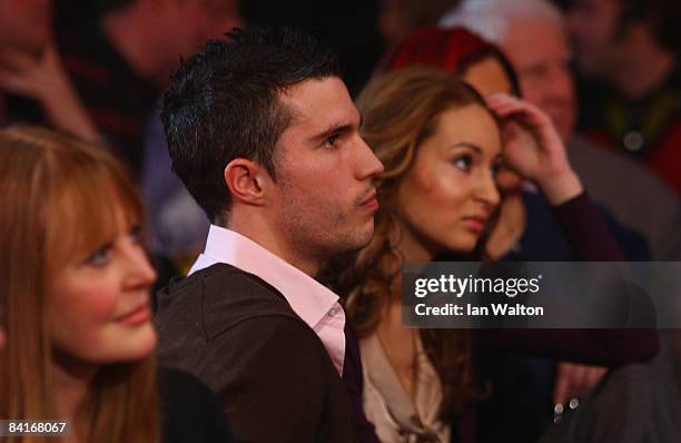 Arsenal football player Robin Van Persie looks on at Phil Taylor of England during his Final match against Raymond Van Barneveld of the Netherlands...