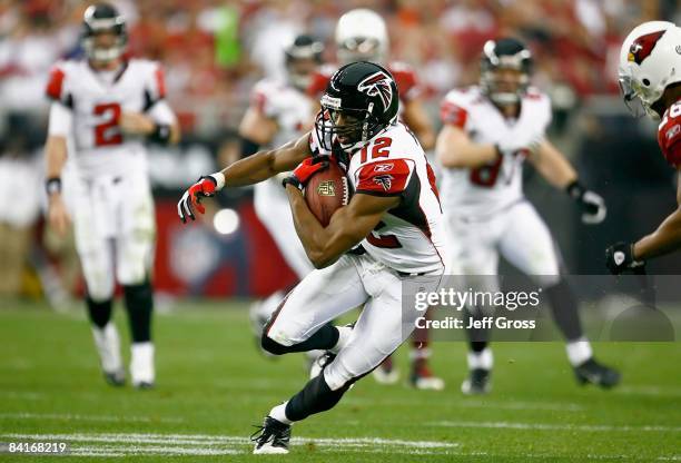 Wide receiver Michael Jenkins of the Atlanta Falcons carries the ball after a reception in the NFC Wild Card Game against the Arizona Cardinals on...