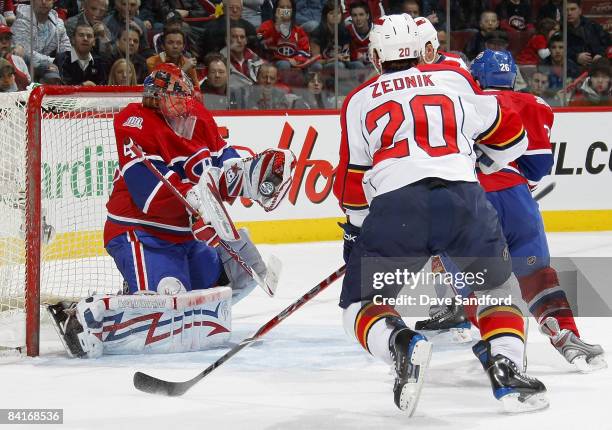 Richard Zednik of the Florida Panthers keeps an eye as Jaroslav Halak of the Montreal Canadiens makes a glove save during their NHL game at the Bell...