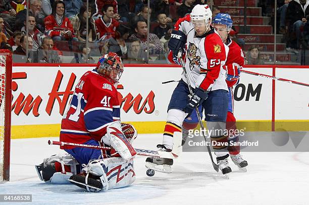 Brett McLean of the Florida Panthers is stopped by Jaroslav Halak of the Montreal Canadiens while Francis Bouillon of the Montreal Canadiens defends...