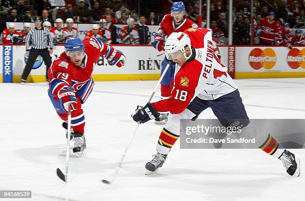 Ville Peltonen of the Florida Panthers takes a slap shot as Andrei Markov of the Montreal Canadiens reaches to block it during their NHL game at the...