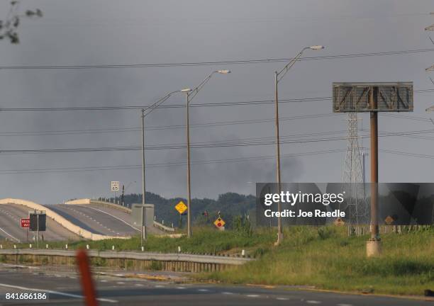 Smoke is seen rising from the Arkema chemical manufacturing and storage facility that burst into flames after Hurricane Harvey's floodwaters knocked...