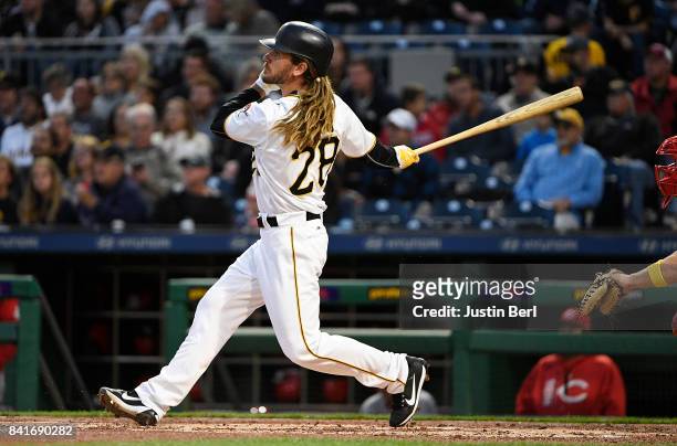 John Jaso of the Pittsburgh Pirates hits an RBI double to right field in the second inning during the game against the Cincinnati Reds at PNC Park on...