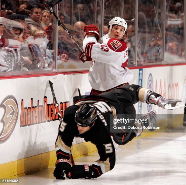 Daniel Carcillo of the Phoenix Coyotes collides into the boards against Steve Montador of the Anaheim Ducks during the game on January 4, 2009 at...