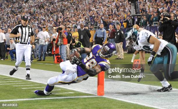 Adrian Peterson of the Minnesota Vikings scores a touchdown during the NFC Wild Card playoff game against the Philadelphia Eagles on January 4, 2009...