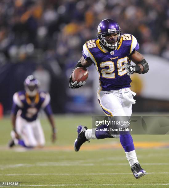 Adrian Peterson of the Minnesota Vikings carries the ball on his way to a touchdown during the NFC Wild Card playoff game against the Philadelphia...
