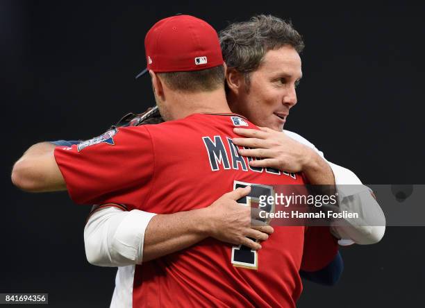 Joe Nathan, who announced his retirement today, hugs former teammate Joe Mauer before the game between the Minnesota Twins and the Kansas City Royals...
